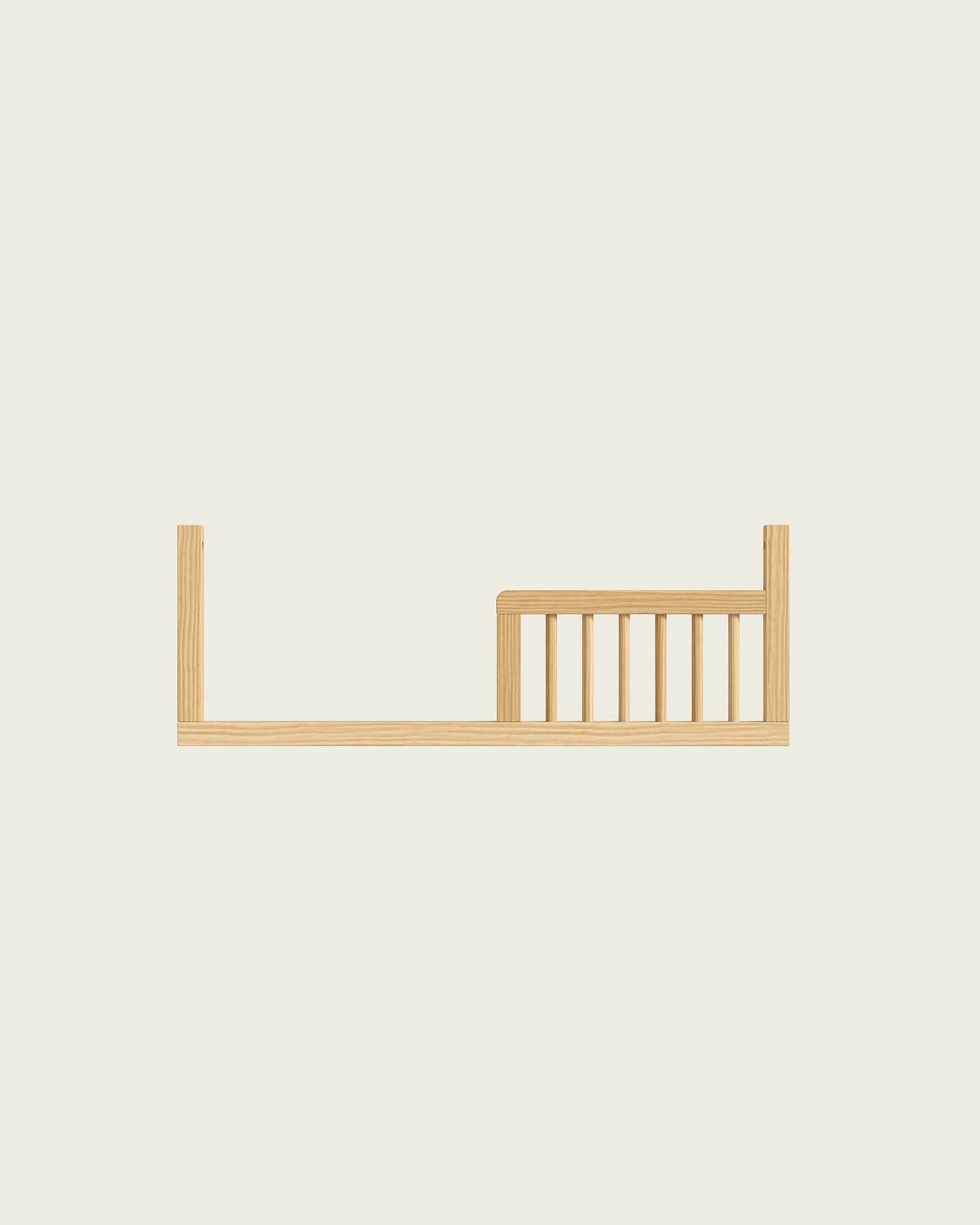 Brown baby crib with slatted sides and mattress with pillow, made of stained wood.