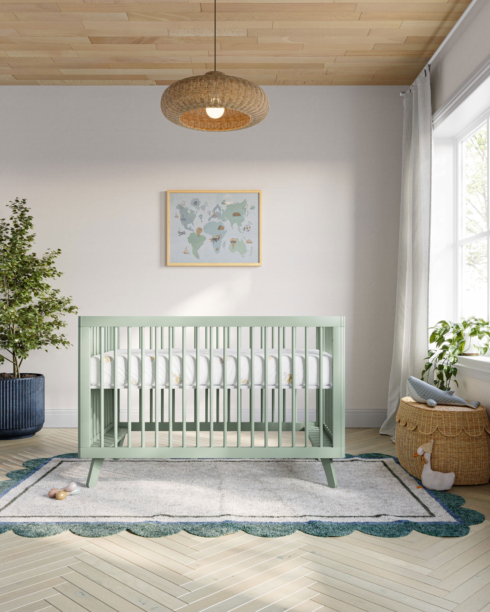 a crib with a light green frame and white mattress