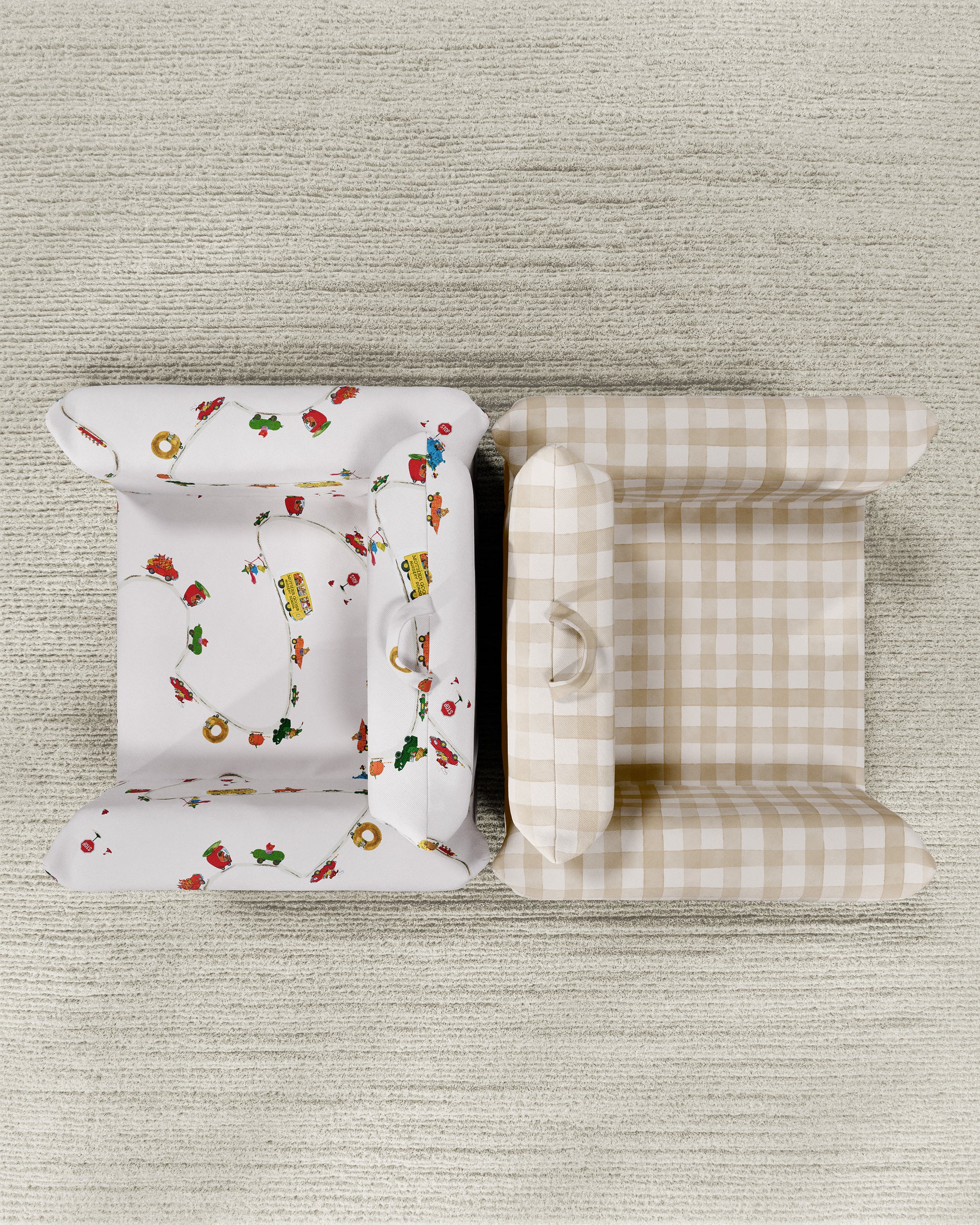 Two folded chairs, one with a white and red pattern and the other with a beige and white checkered pattern