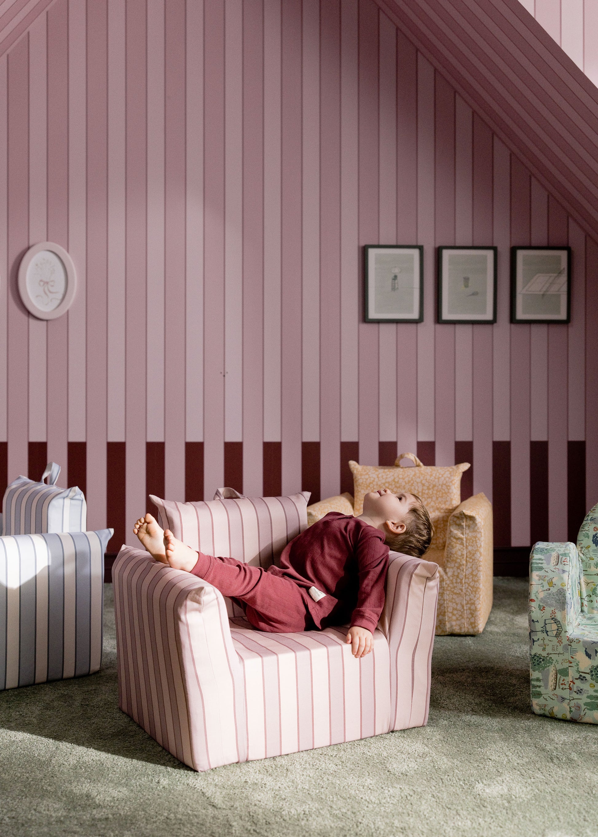 Small armchair with a blue paisley pattern, suitable for a child's room, placed against a blue wall.