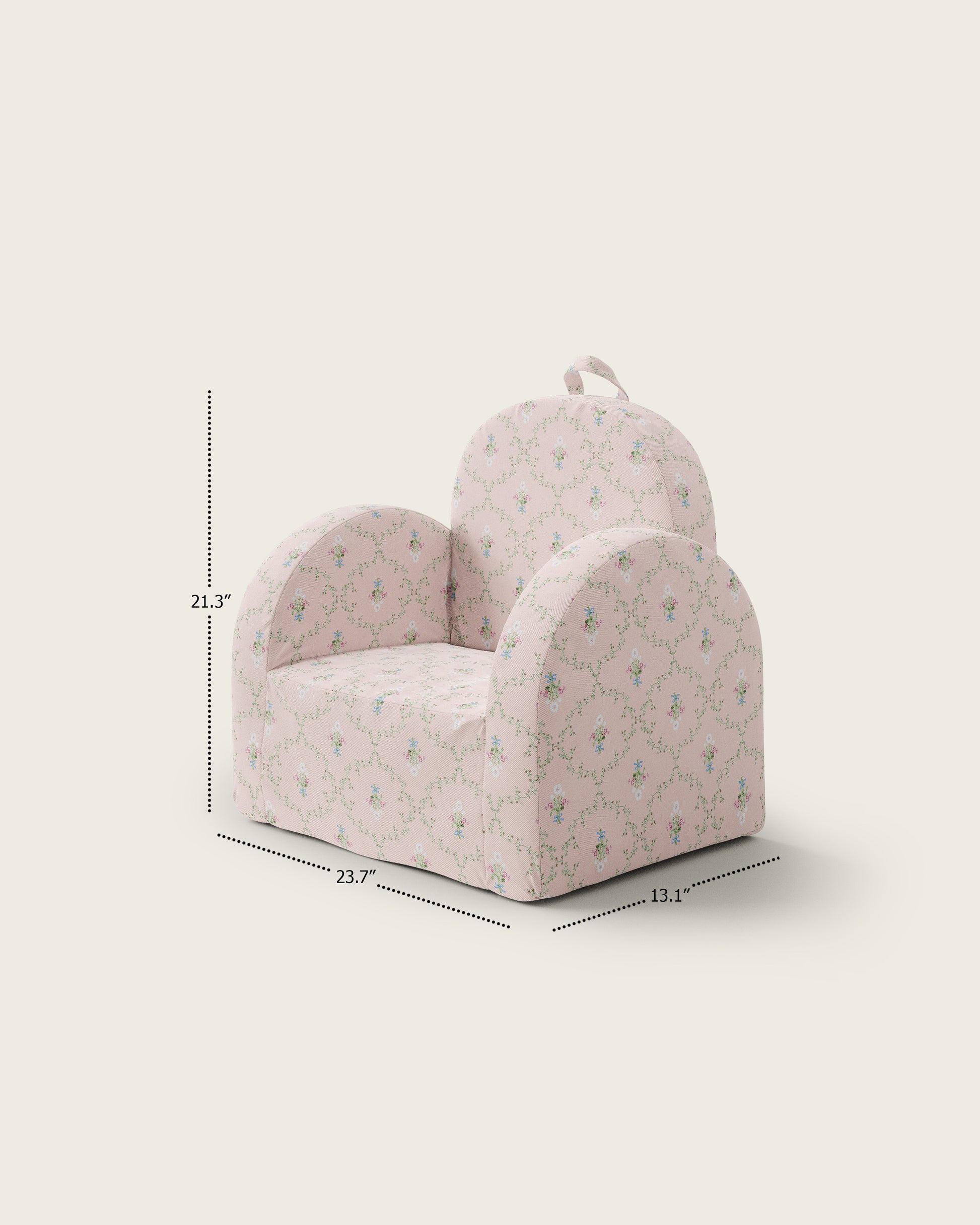 Pink floral children's armchair with a child sitting on it, holding a vintage telephone, in a cozy room setting.